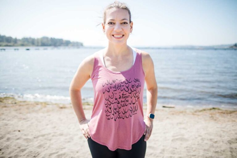 Photo of Laura Jawad, in front of Lake Washington and wearing workout clothing, taken just prior to starting breast cancer treatment.